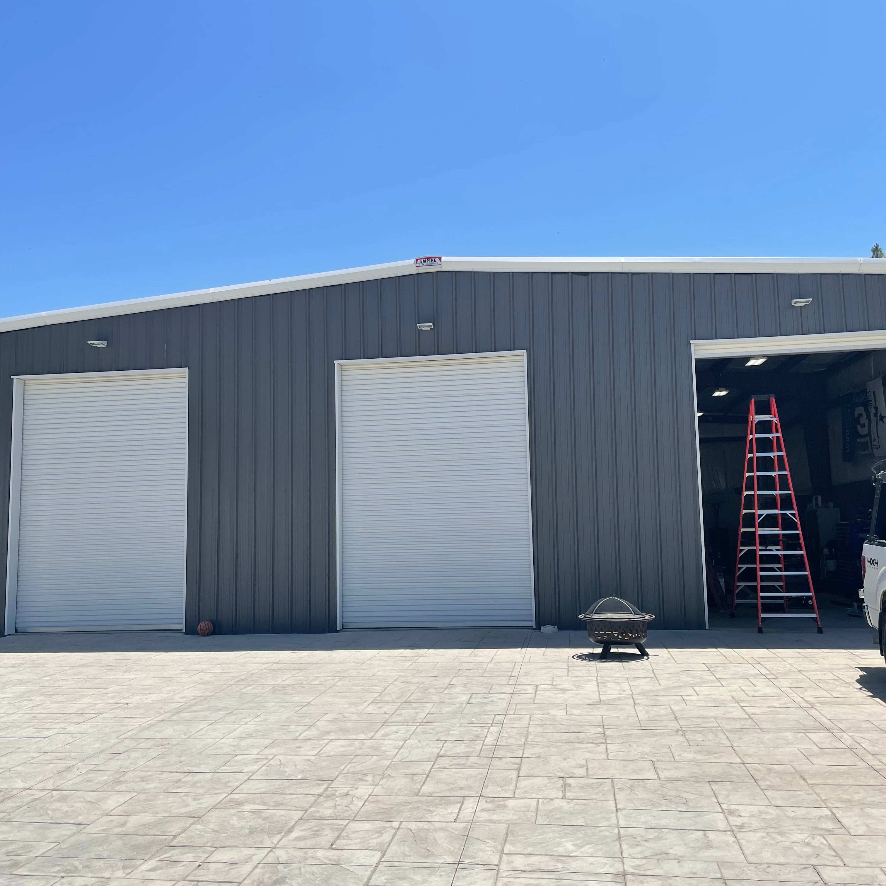Triple commercial rolling-steel overhead doors installed by DoorWorks on an Antelope Valley warehouse