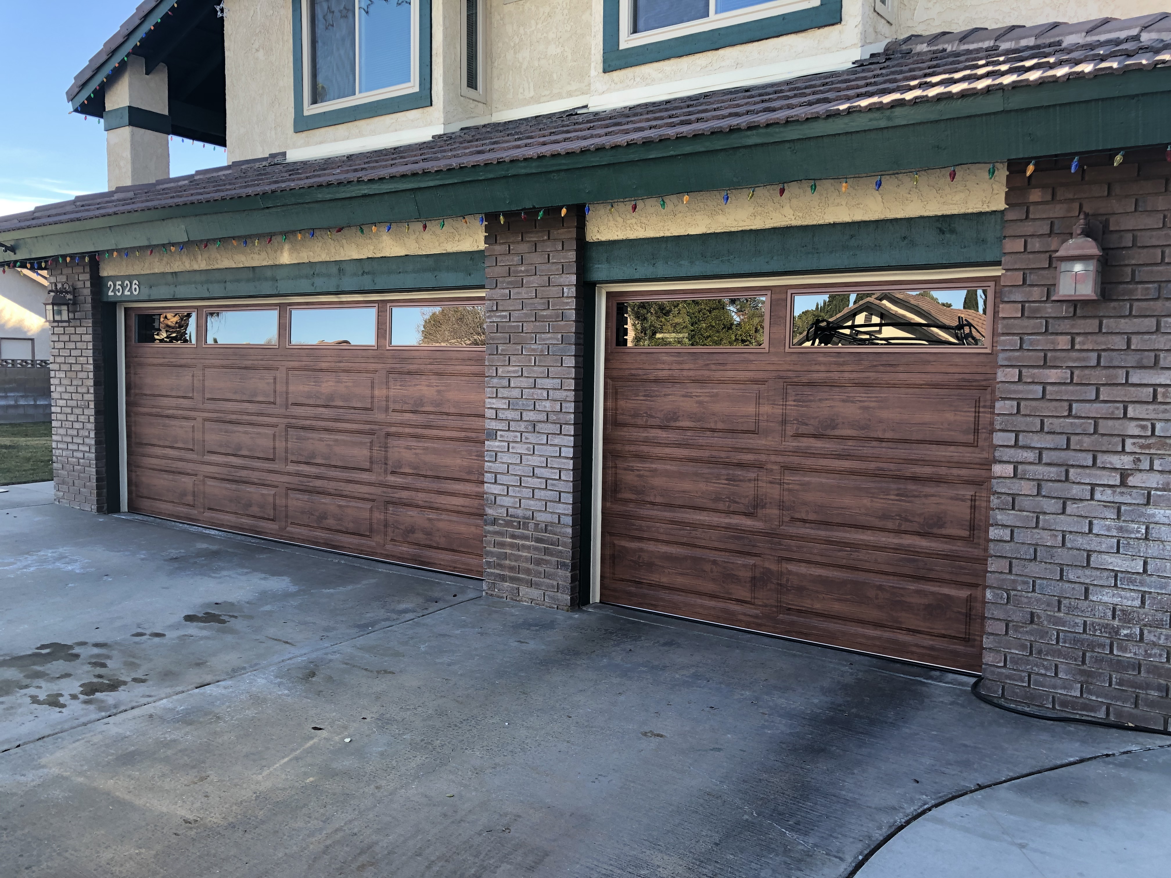 DoorWorks technician servicing an overhead door — real Antelope Valley job site